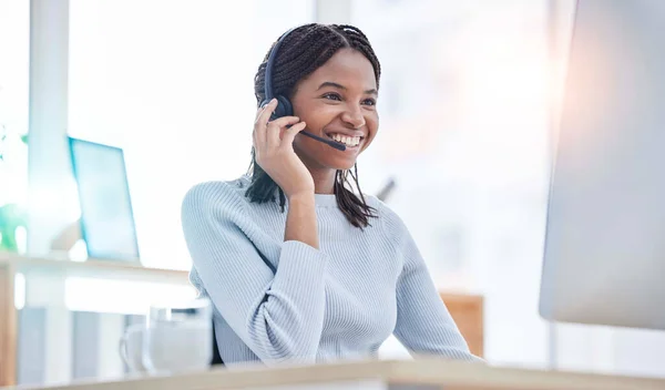 Consulting, call center and black woman at computer for customer service online at office. Technical support professional client communication with headset mic at workplace in Nigeria