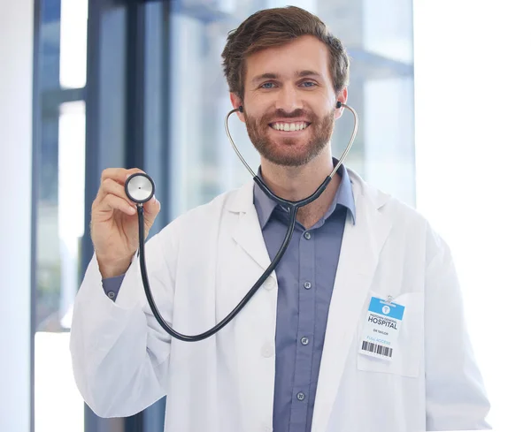 Cardiology doctor and portrait of man at hospital with expert stethoscope for medical evaluation. Healthcare, cardiologist and professional worker with equipment for heart health consulting