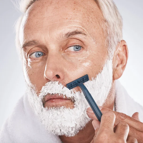 Man face, shaving foam or grooming in self care maintenance or beauty aesthetic on studio background. Zoom, mature model or hair removal cream in facial cleaning, growth control or hygiene skincare.
