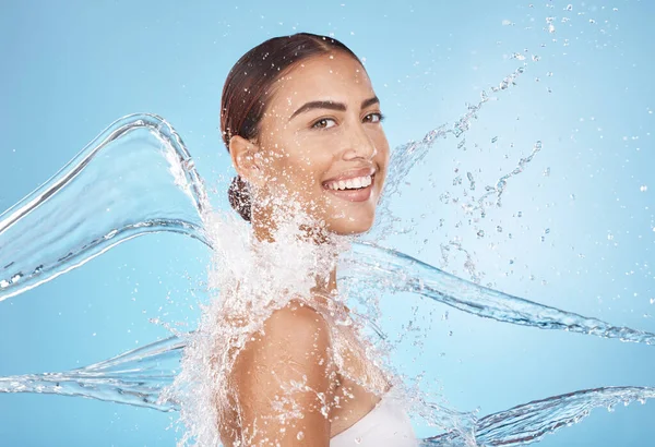 Happy woman, body skincare or water splash on blue background studio in healthcare wellness, Brazil hygiene maintenance or shower grooming. Smile portrait, beauty model or wet water drop for cleaning.