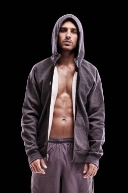 His focus is on total fitness. Studio shot of a bare-chested young man in sportswear standing confidently clipart