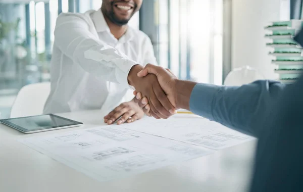 Black man, shaking hands and architecture with architect hiring, interview and onboarding, office and blueprint plan. Human resources, recruitment and partnership with deal, contract and thank you.