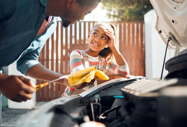 Car problem, child and dad working as a mechanic while teaching daughter to change motor oil and fix vehicle. Black man and girl kid learning, talking and bonding while busy on engine for transport.
