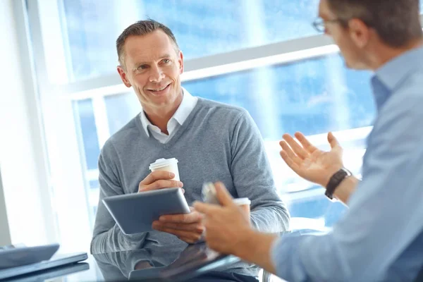 Stock image Business, tablet and men talking, collaboration and planning corporate deal, meeting and conversation. Male entrepreneur, boss and employee have discussion, partnership and target for startup company.