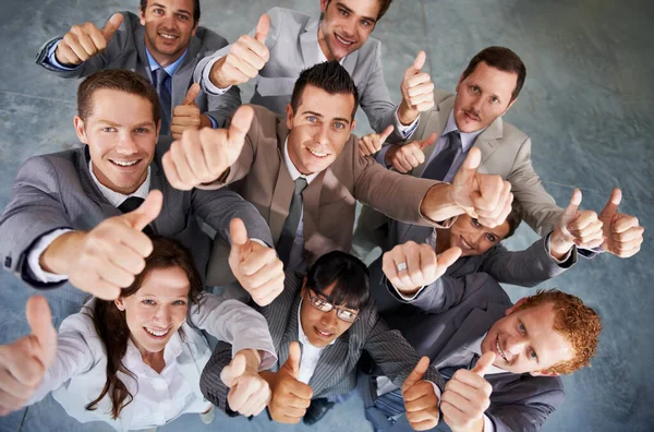 Emphatic approval. Top view of a successful business team giving you an emphatic thumbs up