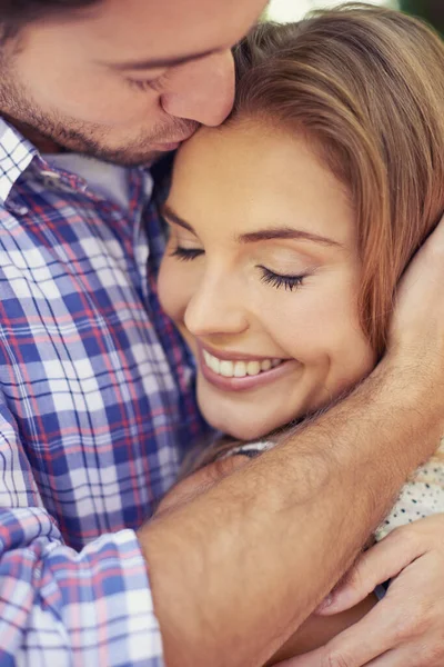 她完全忠于他 一对笑着的年轻夫妇在公园拥抱对方的合影 — 图库照片