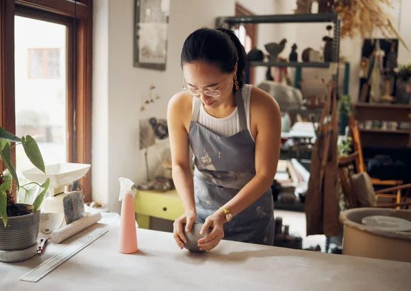 Design, sculpt and pottery business woman with clay for creativity, inspiration and art process in workshop. Creative, small business and asian girl working at artistic workspace in Tokyo, Japan.