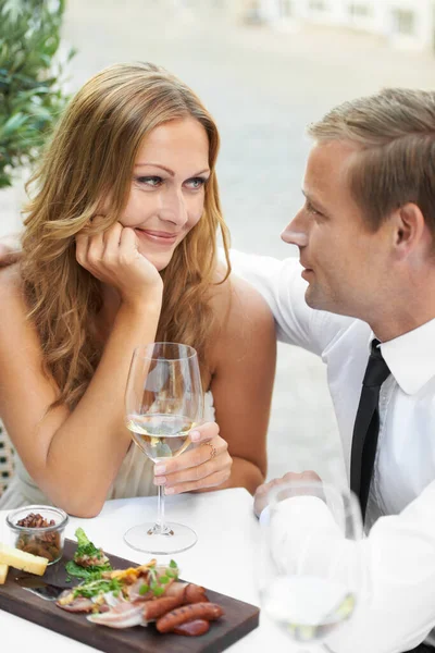 I fall in love eveytime I look into his eyes. A gorgeous couple share a moment in a restaurant