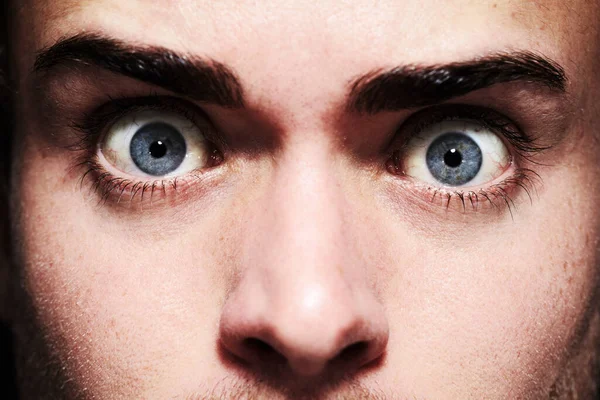 His eyes give away his fear. Closeup portrait of a young man with wide eyes