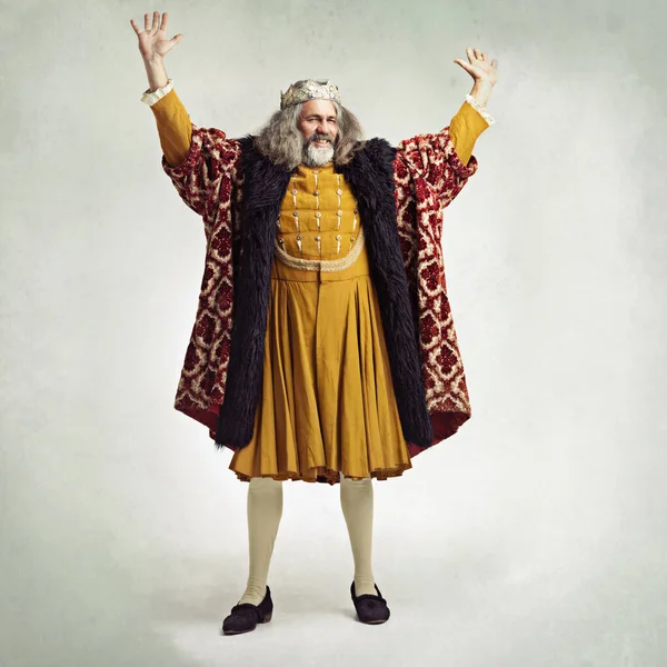 Royal king man, studio and hands in air for power, magic or winning celebration by gray background. Ancient medieval leader, portrait and full body with fantasy, happiness or vintage robe by backdrop.