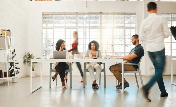 Group of businesspeople working in an office. Diverse group of businesspeople in a office. Diverse architects working together. Businesswomen talking and working together.