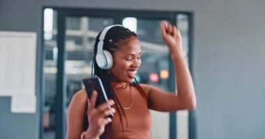 Music, phone and dance with a business black woman walking through her office breakroom while having fun. Relax, radio and energy with a female employee dancing while listening to audio at work.