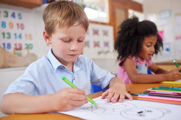 Colouring is a beneficial activity for kids of all ages. preschool students colouring in class