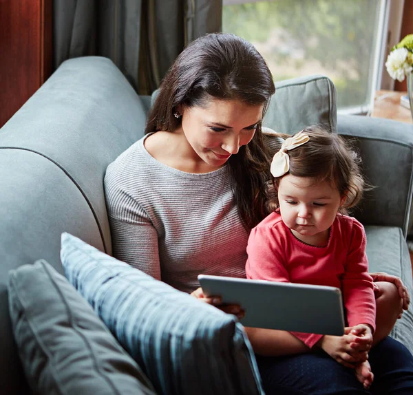 Mother, baby and tablet for video call on sofa in living room for online communication or mobile virtual chat in family home. Mom smile, child and streaming web call on digital tech device on couch.