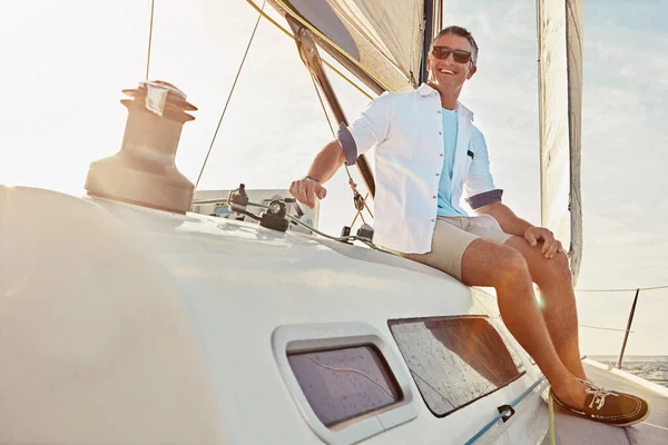 Summer, holiday and man on a yacht for sailing, nature adventure and ocean cruise in Italy. Relax, happy and person on a luxury boat for outdoor zen, vacation and happiness on the water with a smile.