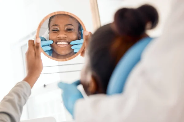 stock image Flashing that million dollar smile. a young woman checking her dental work in a mirror