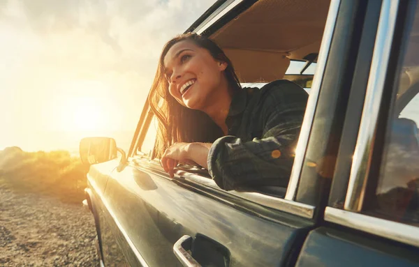 Thinking, travel and road trip with a black woman in a car at sunset during summer vacation or holiday. Nature, window and drive with an attractive young female sitting in transport for adventure.