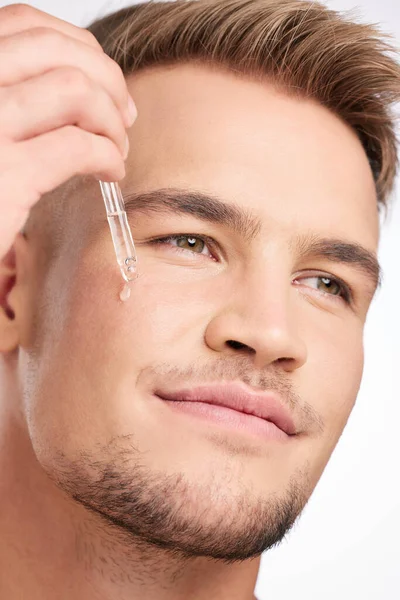 Everyone Has Skincare Secrets Studio Shot Young Man Applying Serum — Stock Fotó