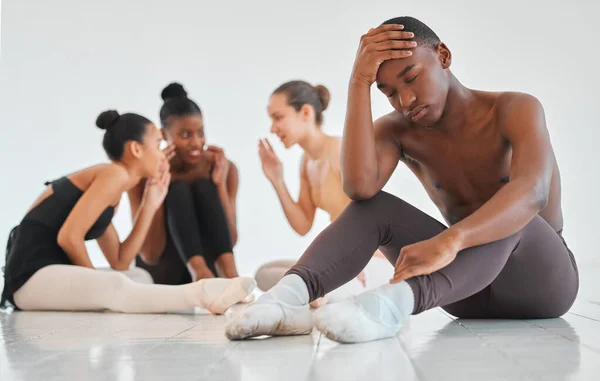 Our dramatic performance is starting to feel too real. a teenage boy looking sad while the rest of his ballet class talks about him behind his back