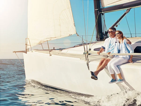 Luxury cruise, couple and yacht while on a boat trip at sea for a adventure, holiday or vacation in summer. Man and woman sailing together on a cruise ship on the ocean with love, happiness and care.