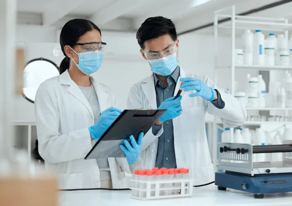 This could change the world. two scientists reviewing a test sample together