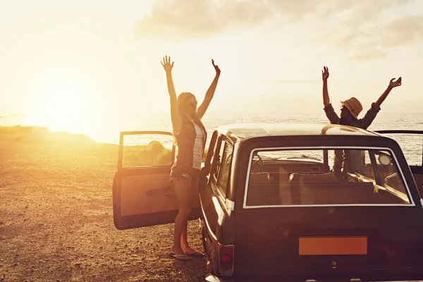 Sunset, road trip and couple of friends at beach for travel, journey and holiday, freedom and celebration. Celebrate summer and happy vintage or retro women with car for vacation and parking by ocean.