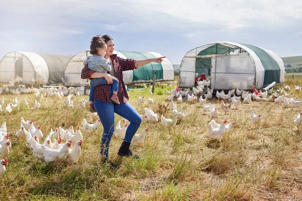 We live where we work and we work where we live. a woman bonding with her daughter on a poultry farm