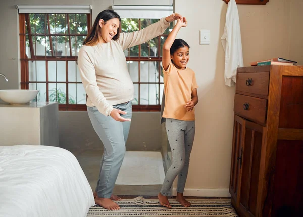 Pregnant mother, child and happy family dancing in home bedroom for bonding, love and care for girl. Smile of kid and woman together in house for pregnancy celebration with happiness and support.