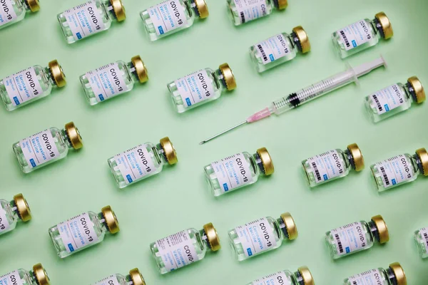 This vaccines got you covered. vaccines and a syringe against a green background