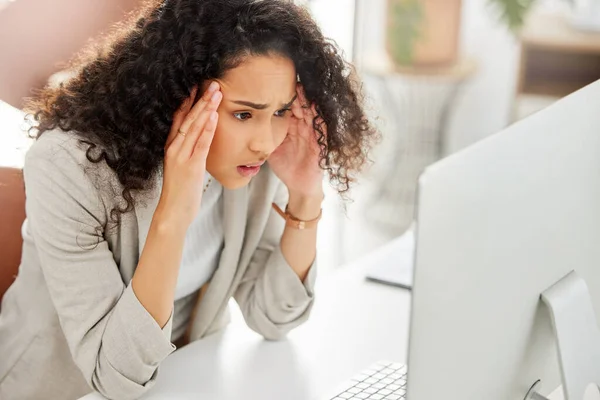 This is really stressing me out now. a young businesswoman looking stressed out while working on a computer in an office