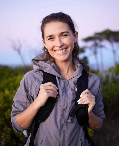 Nature, freedom and portrait of woman hiking in forrest on happy holiday adventure time in Brazil. Travel, wellness and fresh air, hiker trekking in beautiful park landscape with smile and backpack
