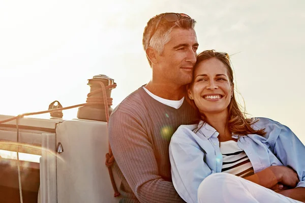 Travel, investment and luxury with couple on yacht for success, relax and wealth on retirement trip. Travel, love and ship hobby with baby boomers man and woman sailing on boat for tropical vacation.
