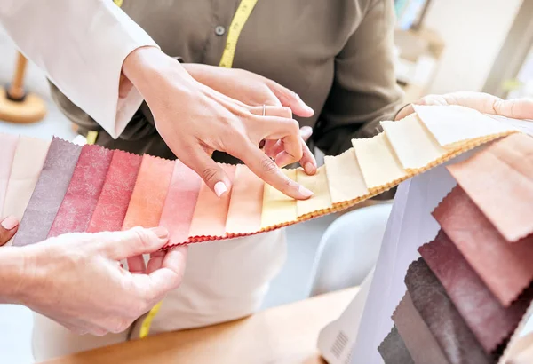 Fashion, hands and women with fabric choice for color in workshop. Teamwork, collaboration and planning of female designers or tailors choosing textile, swatch or colors for clothing in boutique