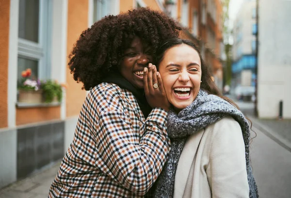 Friends, gossip in ear and women in street laughing at secret joke in city with smile on face. Urban secrets, rumor and whisper in ears, black woman with friend laugh at funny story on walk in town