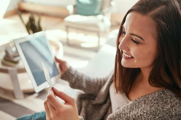 Credit card, digital tablet and woman on a sofa for ecommerce sale, membership or subscription. Girl debit card and online shopping in a living room, happy and excited for purchase or online order.
