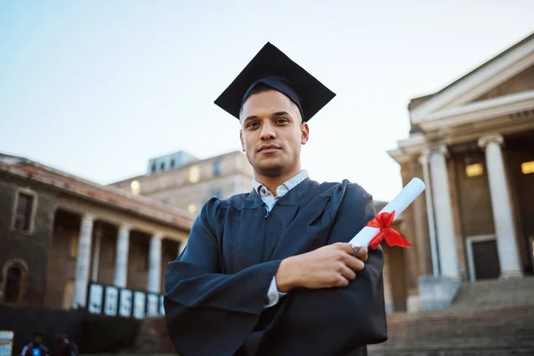 Student graduation, portrait and man with certificate, diploma or degree. University education, college and proud male graduate from Brazil with arms crossed and academic document for learning goals
