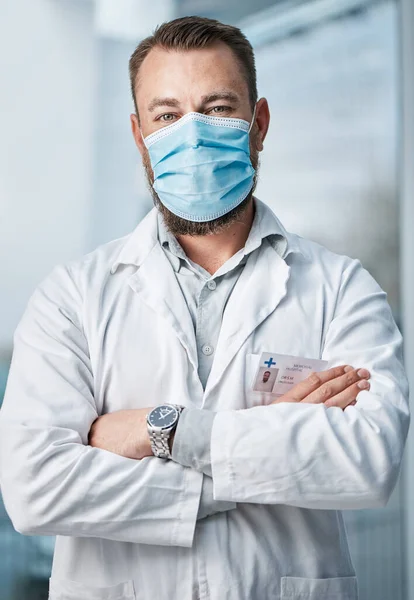 The fight against the virus requires a global effort. Portrait of a medical practitioner wearing a face mask in a hospital