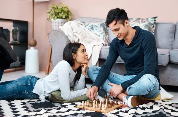 Its all fun and games in self quarantine. a young couple playing a game of chess at home