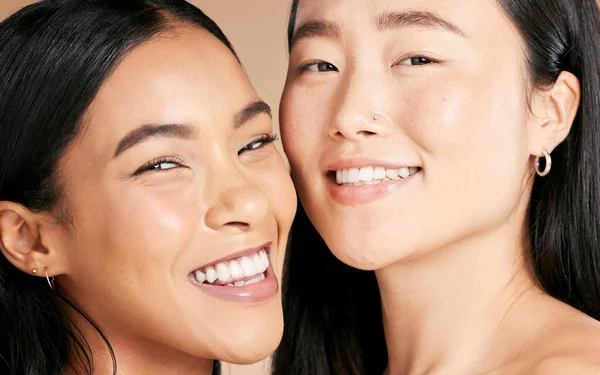 Skincare, cosmetics and portrait of women with makeup isolated on a studio background. Smile, dermatology and face of model friends with happiness for foundation shade diversity on a backdrop.