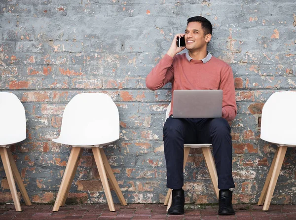 Phone call, recruitment and man on brick wall, sitting in line with hr news, job opportunity and hiring success. Smartphone, waiting room and person on technology for career networking and interview.