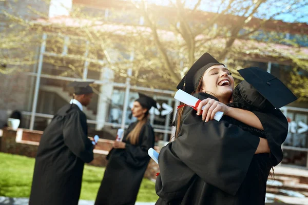 Success is even better when its shared. two happy young women hugging on graduation day