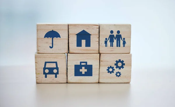 stock image Wooden, cubes or stack in house risk management, security or future protect on background desk mockup or home table. Zoom, building blocks or life insurance in medical, car loan or mock up cog wheel.