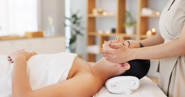 Woman, relax and spa for facial, massage or beauty in healthy skin, wellness or luxury treatment at resort indoors. Female in calm, zen or physical therapy relaxing on massaging table for skincare.