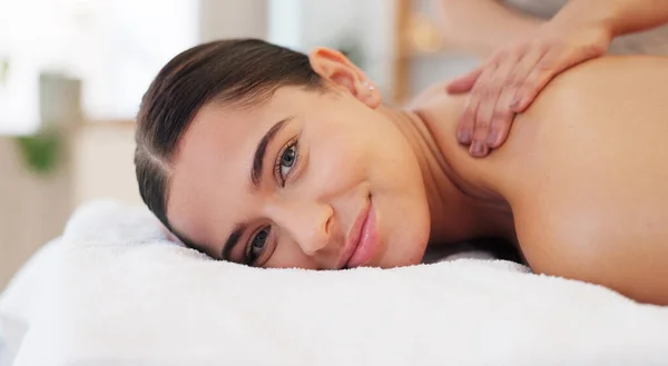 Portrait, masseuse and woman back for massage to relax, happy and enjoy wellness for health, fitness or smile. Peaceful female, calm lady and spa for physical therapy, body treatment or stress relief.