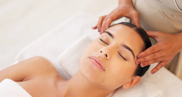 Spa, head massage and calm woman enjoying a relaxing treatment in a wellness, health and beauty center. Relax, peace and therapist doing relaxation therapy for a girl at a luxury natural salon