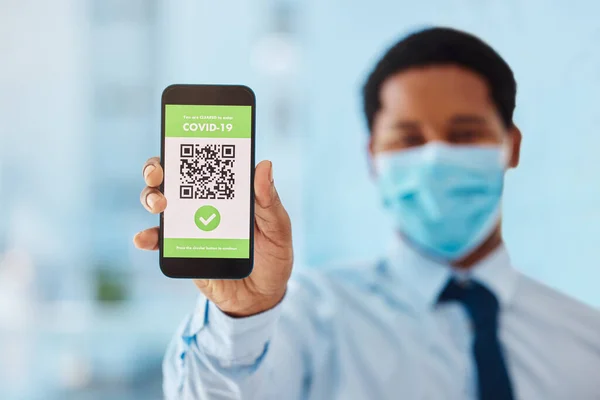 QR code, scan and phone with online covid vaccine certificate by businessman showing mobile screen. App, hand and digital passport of an employee or tourist as new normal travel closeup.