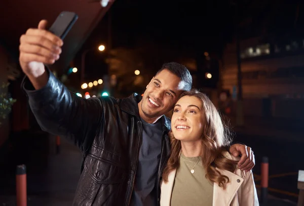 Couple of friends, phone or night selfie on city street or road for social media, profile picture or birthday celebration vlog. Smile, happy or influencer people bonding in dark while live streaming.