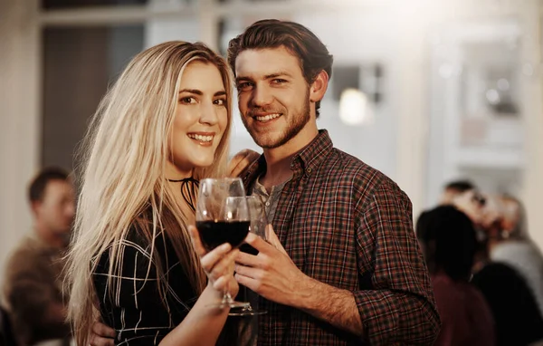 Were always up for a get-together with friends. Cropped portrait of an affectionate young couple enjoying a glass of wine