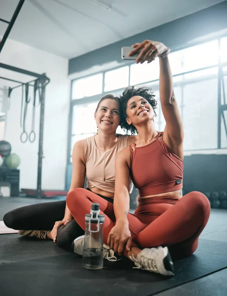 Friends, selfie and fitness with women in gym for workout, social media and wellness blog. Exercise, training and health with girl athlete and phone for online post, internet and sports picture.