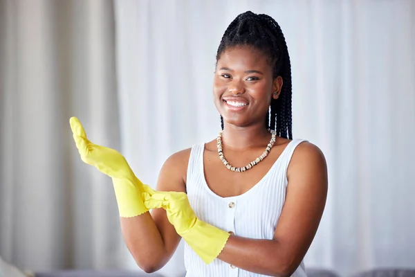 Cleaning, black woman and cleaner gloves portrait of a girl happy about home health care. House maintenance, smiling main and happiness from housekeeper service employee ready for housework chores.